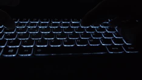 Closeup-of-male-hands-typing-LIBRA-on-a-backlit-notebook-keyboard-in-the-dark-to-do-research-on-the-decentralized-cryptocurrency-to-be-launched-by-Facebook-to-bank-the-unbanked