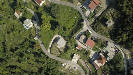 Aerial-birds-eye-view-of-buildings,-built-on-the-hillside-in-Risan,-Montenegro