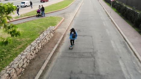 white-woman-skating-on-longboard-down-the-street-in-Montevideo-Uruguay