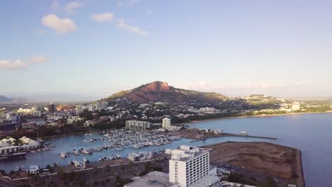 Drone-rising-to-reveal-Townsville-city-and-Castle-Hill-on-a-sunny-morning