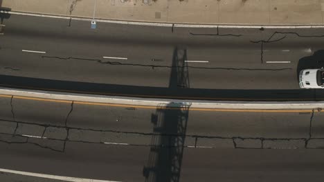 Afternoon-drone-view-above-the-Pacific-Coast-Highway-near-the-Santa-Monica-Beach,-California