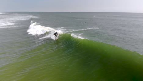 Epic-drone-tracking-shot-of-surfer-riding-a-wave
