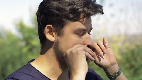 Male-fixing-mustache-outdoor-slow-motion
