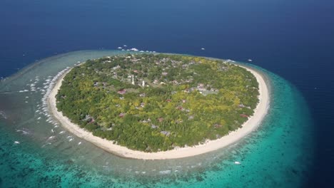 Aerial-forward-tracking-shot-panning-down-of-Balicasag-Island,-Bohol,-the-Philippines