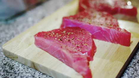 Cooking-tuna-steak-with-spices-on-wooden-board-for-a-high-protein-dinner-at-home