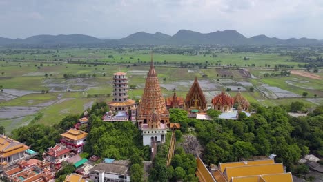 Aerial-Drone-shot-backing-away-from-Wat-Tham-Sua-Temple,-Kanchanaburi,-Thailand