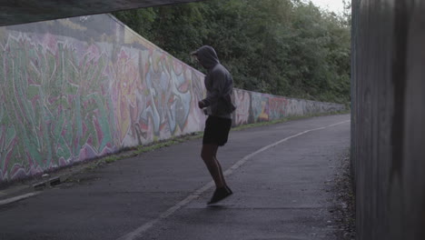 Wide-Shot-of-Athletic-Man-Jumping-Rope-in-an-Underpass---Ungraded