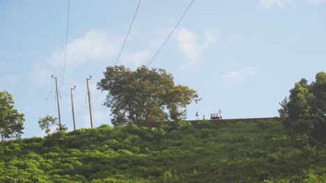 Eine-Gruppe-Afrikaner-Auf-Einem-Berggipfel-Mit-Strommasten