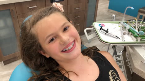 Young-girl-getting-braces-in-dental-office