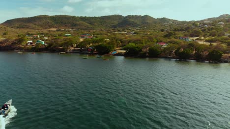 Aerial-view-of-Carriacou-with-a-speed-boat-in-the-foreground