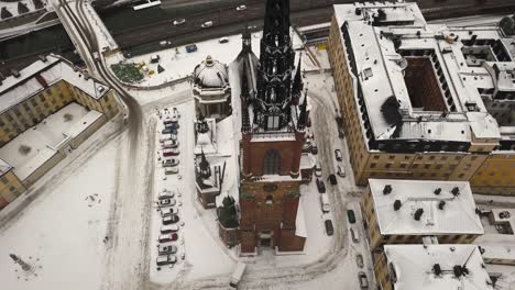 Rotating-top-down-view-over-charming-church-with-artistic-steeple-in-the-famous-town-of-Stockholm