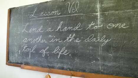 Old-chalkboard-with-old-school-lesson-in-one-room-schoolhouse