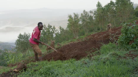 Wide-shot-of-Man-Farming-on-Hillside-in-the-morning