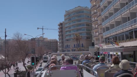 Tourist-enjoying-the-warm-weather-on-a-tour-bus-in-Malta-circa-March-2019