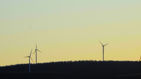 Wind-power-generator-turbines,-at-a-sunny-evening,-in-Hoga-Kusten,-Vasternorrland,-Sweden