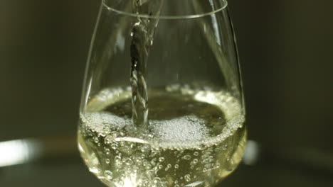Close-Up-Shot-of-White-Wine-Being-Poured-In-A-Wine-Glass