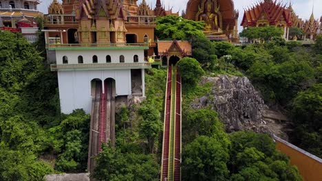 Aerial-Drone-climbing-reveal-of-Wat-Tham-Sua-Temple,-Kanchanaburi,-Thailand