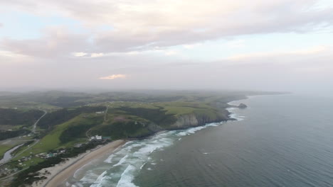 Cinematic-aerial-flying-at-sunrise-over-coast-of-East-London-South-Africa