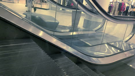 Escalator-in-mall-with-people-riding-it