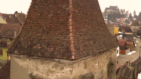 Beautiful-view-of-the-roof-tops-with-some-snow-of-the-houses-and-other-medieval-buildings-of-Sighisoara-town