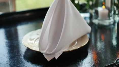 Folded-white-napkin-on-plate-on-wedding-table