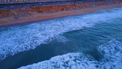 Drone-shot-over-an-isolated-beach,-in-Huntington-Beach,-CA