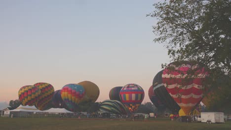 Ein-Zeitraffer-Von-Heißluftballons,-Die-Sich-An-Einem-Sommermorgen-Bei-Einem-Heißluftballonfestival-Füllen