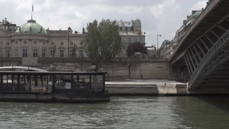 SLOW-MOTION:-Famous-Boat-Cruise-in-Paris-on-river-Seine-with-tourists-on-ship