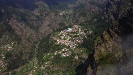 AERIAL:-Small-town-between-clouds-in-the-mountains-in-Madeira