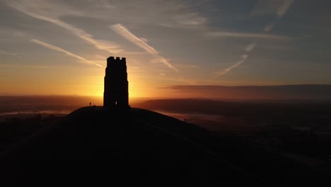 Orbiting-the-golden-sunrise-over-Glastonbury-Tor-and-the-misty-fields-below