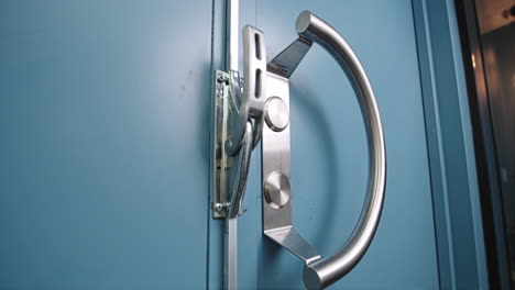 Detailed-video-of-blue-industrial-door-with-big-door-handle