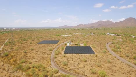 Aerial-from-a-distance-drone-descent-on-an-array-of-solar-panels-in-the-Sonoran-desert-near-Taliesin-West,-Scottsdale,-Arizona-Concept:-environment,-alternative-energy,-sun-power