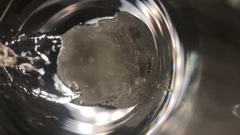 Slow-motion-and-extreme-close-up-shot-of-a-glass-of-champagne-being-filled-up-with-focus-on-the-foam-and-bubbles