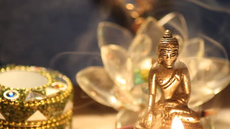 Buddha-statue-with-candle-lights-and-incense-smoke-close-up-12