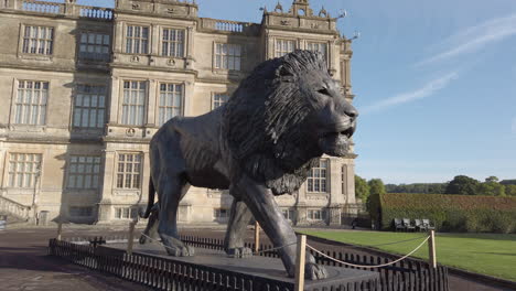 Wide-shot-walking-pan-of-a-giant-statue-of-a-Lion-at-a-safari-park