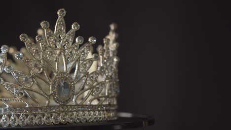 Beauty-pageant,-bride's-or-queen's-crown-on-a-turning-display-as-in-a-museum,-illuminated-with-black-background
