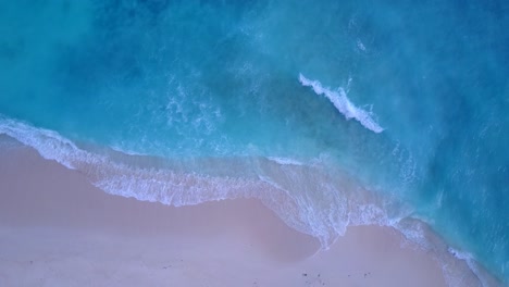 Big-white-waves-of-azure-sea-foaming-over-pink-sand-of-exotic-beach-in-Bermuda,-beautiful-sea-texture,-copy-space