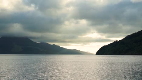 Beautiful-view-from-boat-of-ocean,-hills-and-clouds-in-Marlborough-Sounds,-New-Zealand