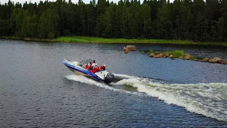 Family-aboard-motorboat-sailing-on-lake