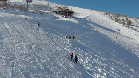 Men-and-snowcat-working,-snow-grooming-on-a-ski-slople-in-Bansko,-Bulgaria