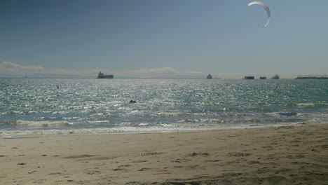 Sunny-beach-with-kites-and-ships