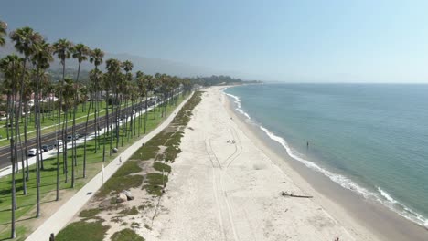 Low-altitude-aerial-number-2-of-an-empty-beach-in-Santa-Barbara,-California-during-a-warm-sunny-day