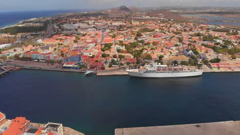 Freewinds-cruise-line-docked-in-St-Anna-Bay-harbour-in-Willemstad,-Curacao