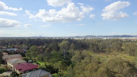 Aerial-drone-rising-shot-to-reveal-Brisbane-CBD-in-background-with-small-aircraft