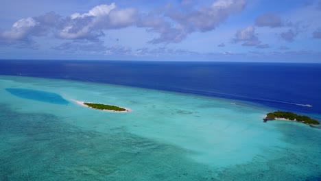 Paradise-tropical-scenery-of-small-islands-with-lush-vegetation-inside-large-turquoise-lagoon-with-calm-water-in-the-middle-of-Indian-ocean