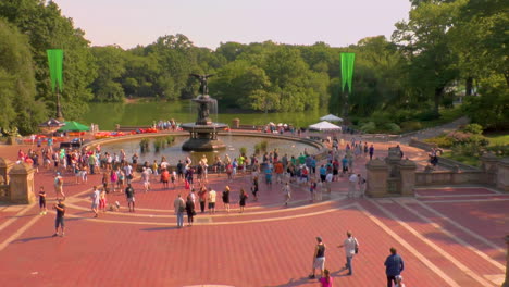 Pan,-Bethesda-Fountain-in-New-York-City's-iconic-Central-Park-on-a-summer-day-as-tourist-mill-around-in-the-distance