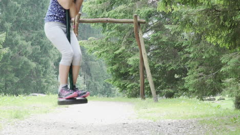 Little-girl-with-red-hair-has-fun-while-she-stands-on-a-pulley-in-the-Italian-Alps,-slow-motion