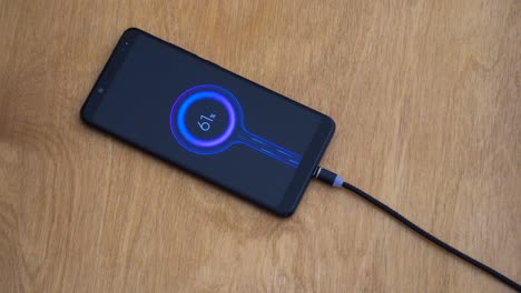 Magnetic-charge-wire-hunts-and-connects-to-smartphone-to-recharge,-close-up