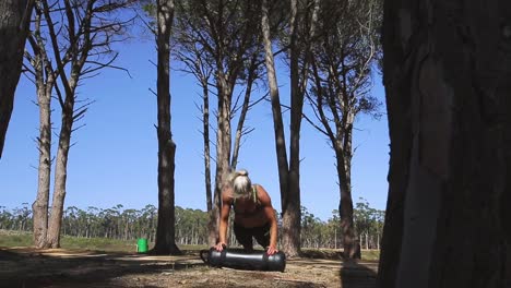 A-young-woman-doing-strength-exercises-in-between-trees
