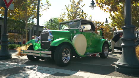 Vintage-green-convertible-car-on-display-at-California-car-show,-truck